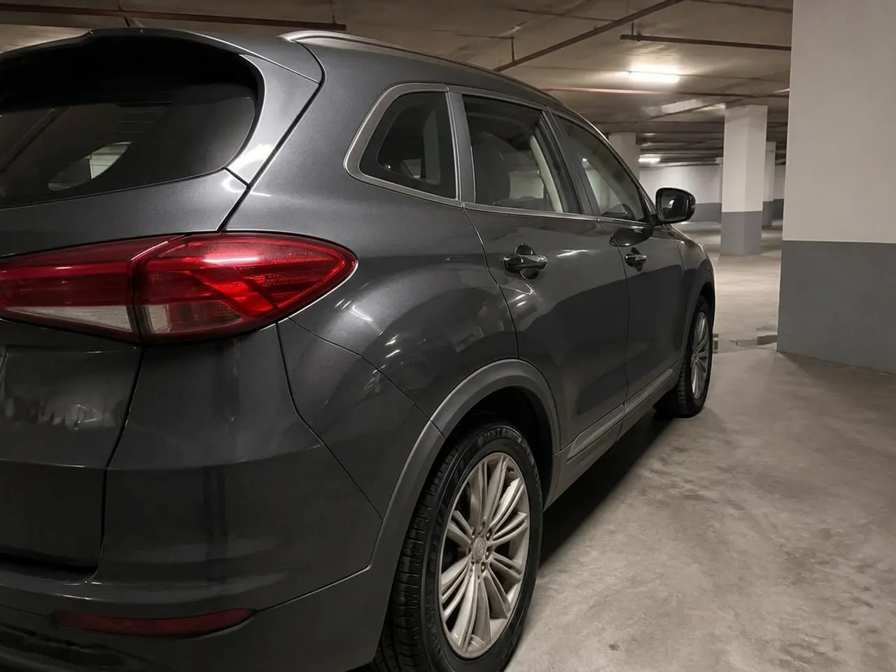 Same rear quarter panel after a hand wash: clean paint and decontaminated wheel