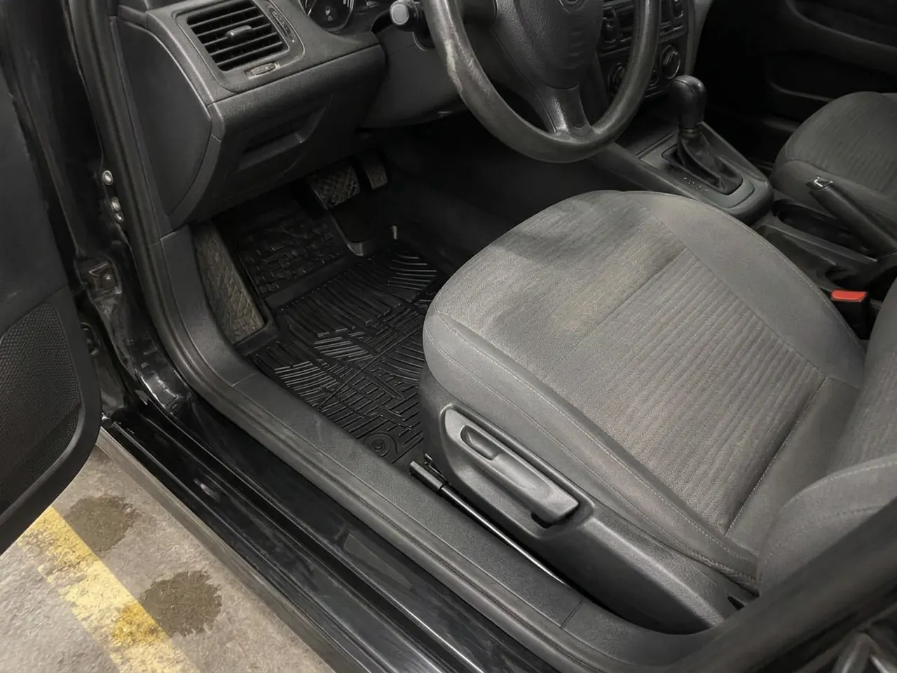 Same cabin after full interior detailing: clean floor mat, dust-free seat and plastics
